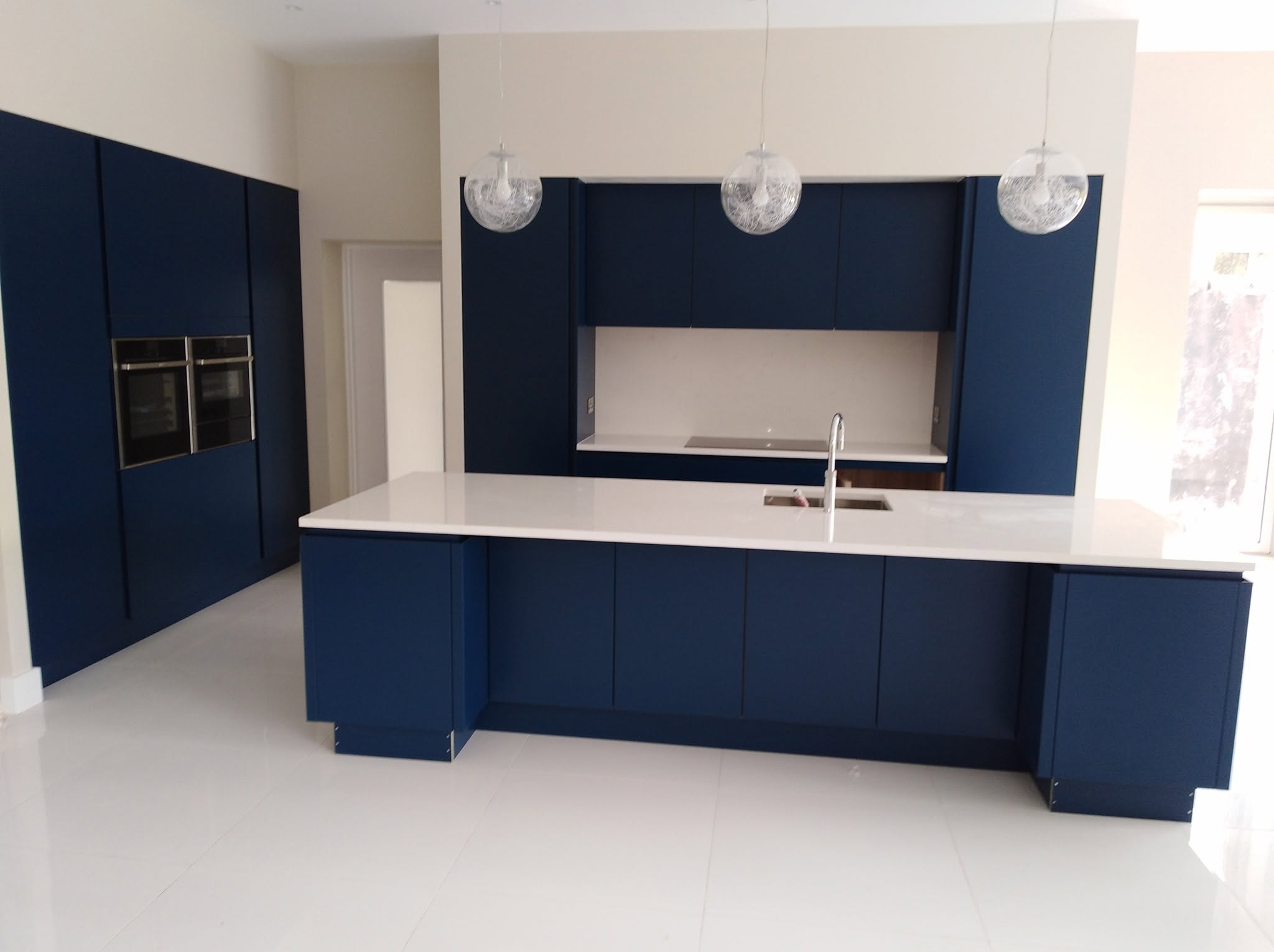 Navy blue kitchen renovation with island, completed by Lorcan Construction in Dublin